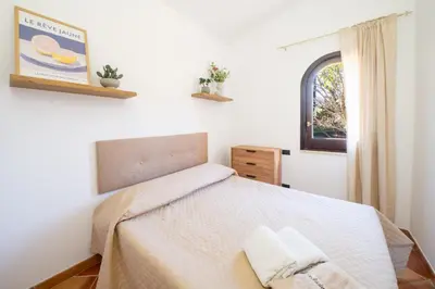 a bedroom with a bed with two towels on it at Villa Eden con piscina a Scopello in Castellammare del Golfo