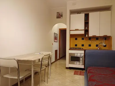 a kitchen and dining room with a table and chairs at BB45 in Palermo