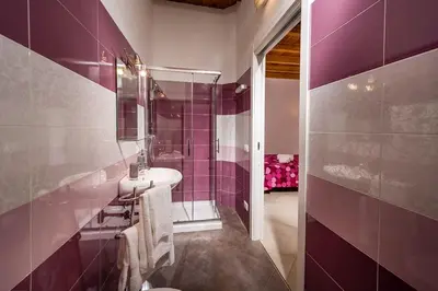 a purple bathroom with a sink and a shower at Il Cortile in Castellammare del Golfo