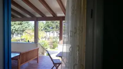 a view of a porch with a table and a bench at Villa Ancora Bed & Breakfast in San Vito lo Capo