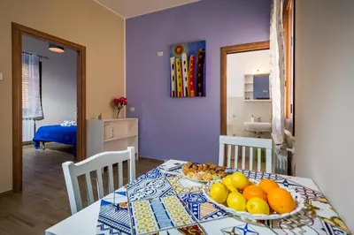 a dining room table with a bowl of fruit on it at Antico Canale in Castellammare del Golfo