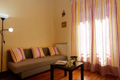 a living room with a couch and a table at Casa Matrangela in Palermo