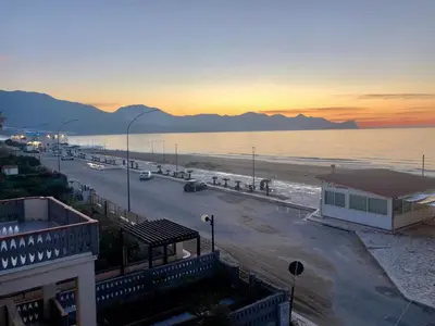 a view of a beach and the ocean at sunset at Tonnara Apartments in Alcamo Marina