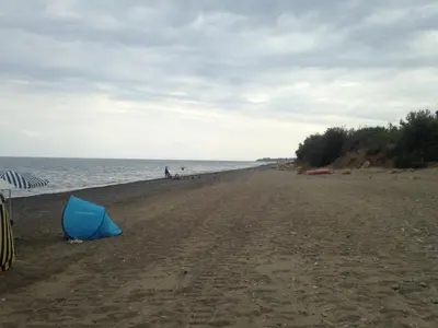 a blue object sitting on a beach next to the water at Le 3 tartarughe in Lascari