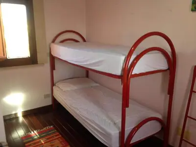 two bunk beds in a room with a window at Le 3 tartarughe in Lascari