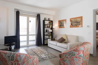 a living room with a couch and a tv at Overseas - Penthouse with terrace - Attico - Palazzo San Matteo in Palermo