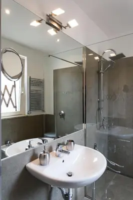 a bathroom with a sink and a shower and a mirror at Overseas - Penthouse with terrace - Attico - Palazzo San Matteo in Palermo