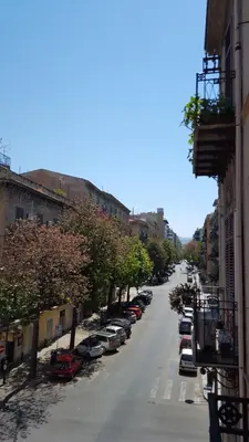 a street with cars parked on the side of a building at CasaLù in Palermo