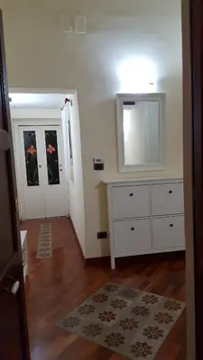a living room with a dresser and a mirror at CasaLù in Palermo