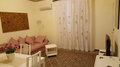 a living room with a couch and a curtain at CasaLù in Palermo