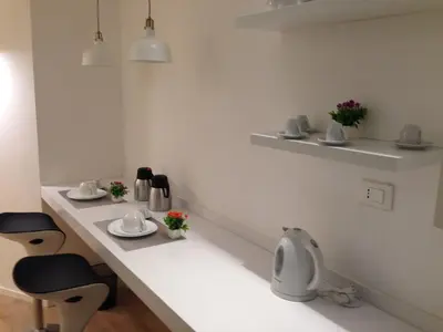 a room with a counter with two chairs at Dante 58 in Palermo