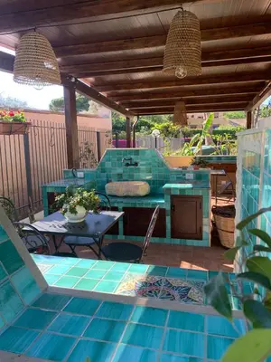 an outdoor patio with a table and a bench at Green Garden 2017 in Mondello