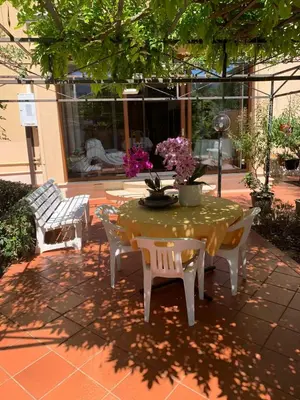a table and chairs in a patio with a table and chairs at Green Garden 2017 in Mondello