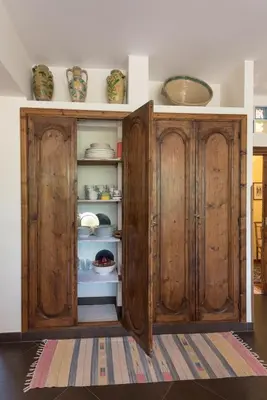 an old wooden cabinet with dishes in it at Green Garden 2017 in Mondello