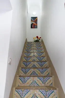 a staircase with a blue and white tile floor at Casa Tiziana in Castellammare del Golfo
