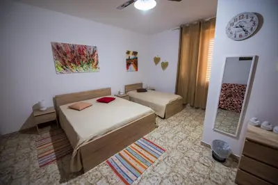 a bedroom with a bed and a mirror and a clock at Alle Vigne Affittacamere in Alcamo