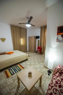a hotel room with a bed and a table at Alle Vigne Affittacamere in Alcamo