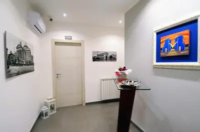 a hallway with a door and a painting on the wall at B&B Le Porte Del Centro in Palermo