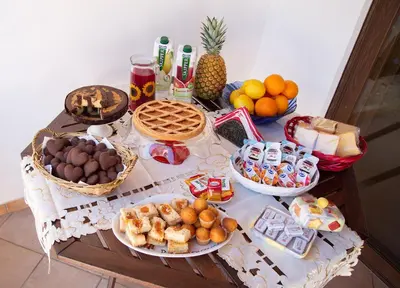 a table with many different types of food on it at B&B Il Girasole in Balestrate