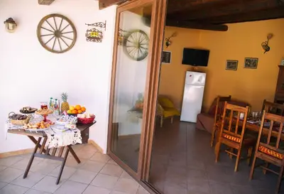 a dining room with a table and a mirror at B&B Il Girasole in Balestrate