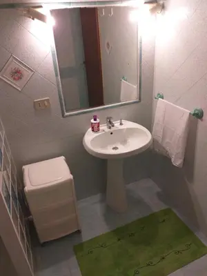 a bathroom with a sink and a toilet and a mirror at B&B Il Girasole in Balestrate