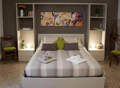 a bedroom with a bed with two towels on it at Casa Gaia Palermo in Palermo