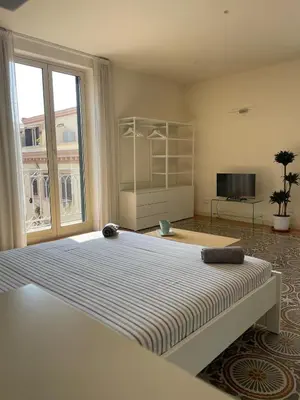 a bedroom with a large bed with a large window at Le Stanze di Federico apartment e Costanza Luxury apartment in Palermo