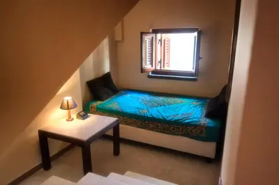 a small room with a bed and a window at Villa Sole in San Vito lo Capo