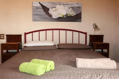 a bed with two lime green towels on it at B&B Pisani in Palermo