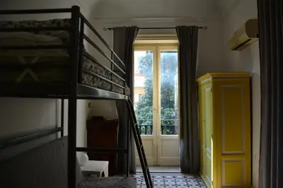 a bedroom with two bunk beds and a window at il lapino in Palermo