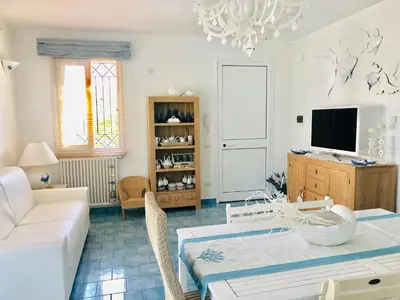 a living room with a couch and a tv at Villa Camelie in Campofelice di Roccella
