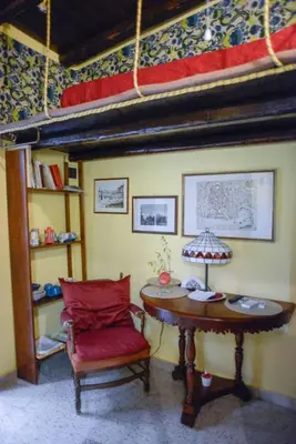 a room with a chair and a table and a bunk bed at Millimetro in Palermo