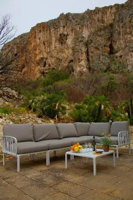 a couch sitting in front of a mountain at Villa Firriato in San Vito lo Capo