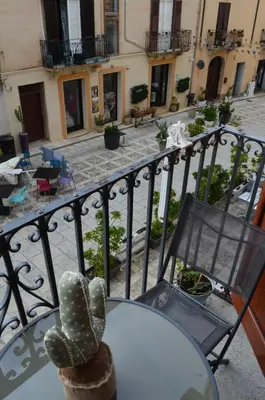 a cactus sitting on top of a table on a balcony at Casa vacanza Nicuzza in Castellammare del Golfo
