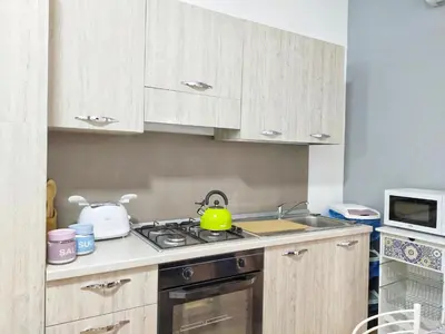 a kitchen with a sink and a stove top oven at Casa vacanza Nicuzza in Castellammare del Golfo