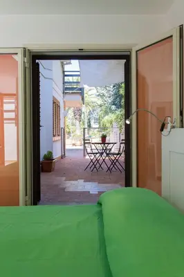 an open door to a patio with a table outside at Piccola Oasi in Mondello