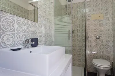 a bathroom with a sink and a toilet and a shower at Piccola Oasi in Mondello