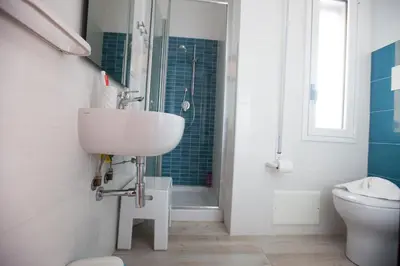 a bathroom with a sink and a toilet and a shower at Appartamenti Cala Azzurra in Scopello