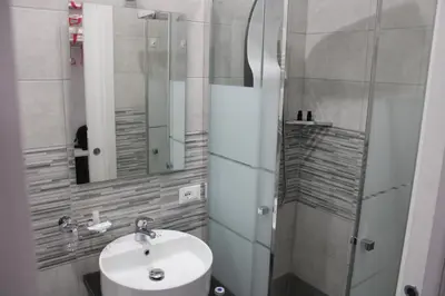 a bathroom with a sink and a mirror at Ri.Mo's Rent Room in Palermo