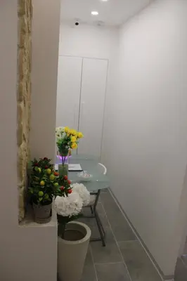 a room with a table with flowers on it at Ri.Mo's Rent Room in Palermo