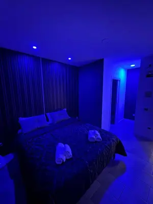 a bedroom with a bed with two slippers on it at Ri.Mo's Rent Room in Palermo