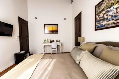 a bedroom with a bed and a desk at Casa Nostra B&B in Palermo