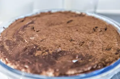 a chocolate cake in a pan on a table at Casa Nostra B&B in Palermo
