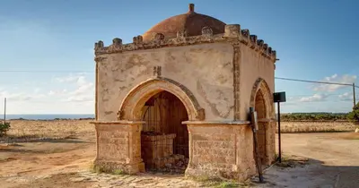 an old building with a gate in a field at holiday home LG in San Vito lo Capo