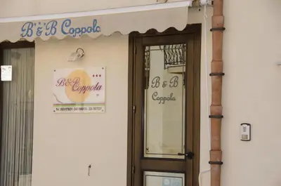a door to a building with a sign on it at B&B Coppola in Castelluzzo