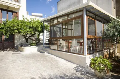 a building with large glass windows on the side of it at B&B Coppola in Castelluzzo
