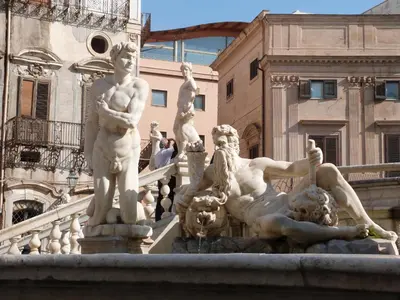 a statue of a man laying on a staircase at Casa Principe Maqueda in Palermo