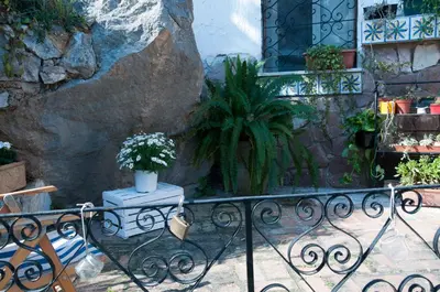 a balcony with a potted plant on a table at Addumari in Palermo