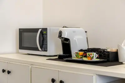 a microwave sitting on top of a kitchen counter at Bilocale in Centro in Palermo