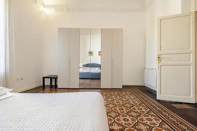 a bedroom with a bed and a mirror at Bilocale in Centro in Palermo